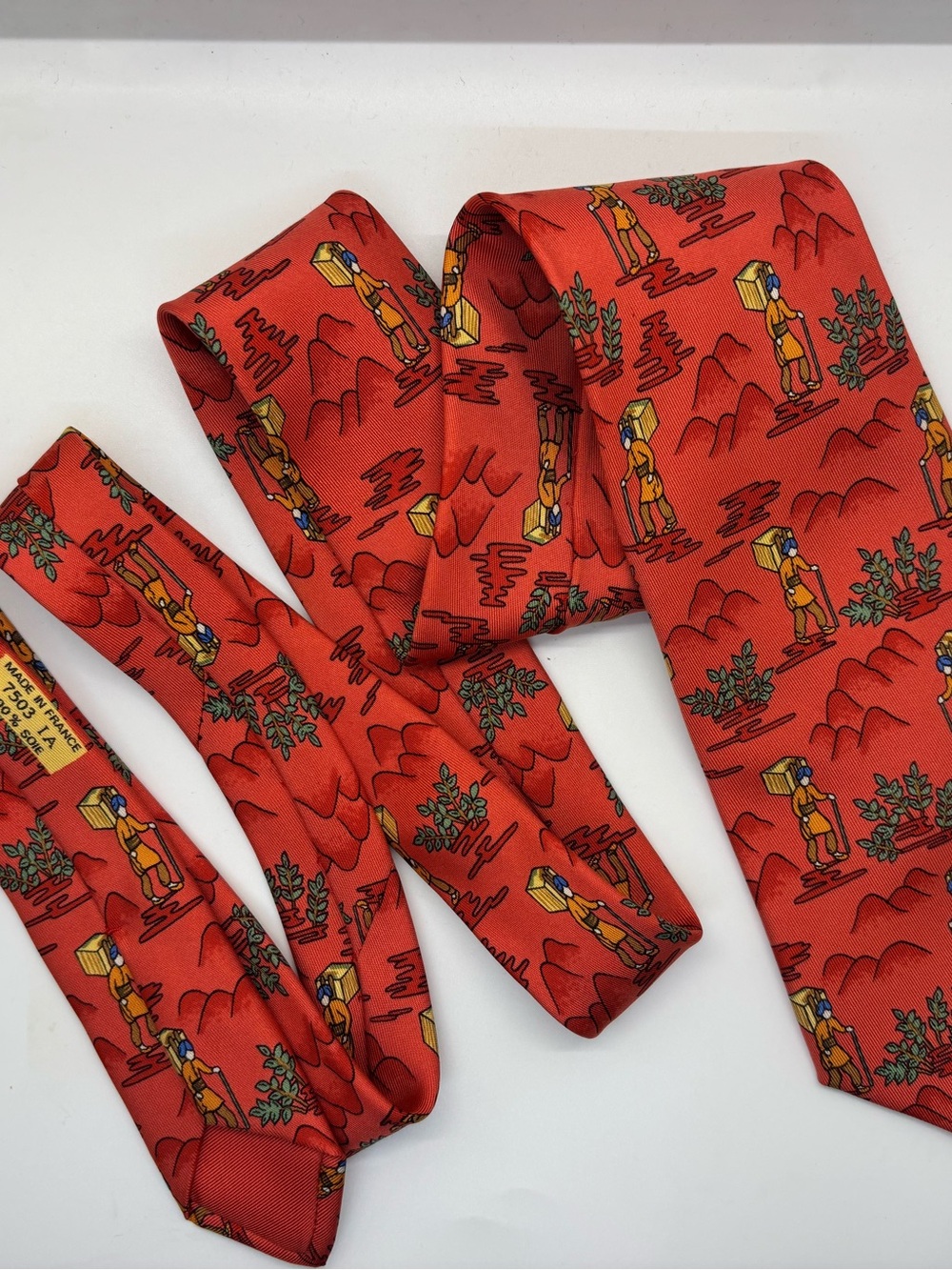 Hermés 100% Silk Red Men’s Necktie with Whimsical Traveler Motif